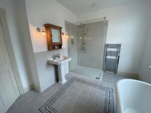 New bathroom installation with a new shower, sink, radiator and bath