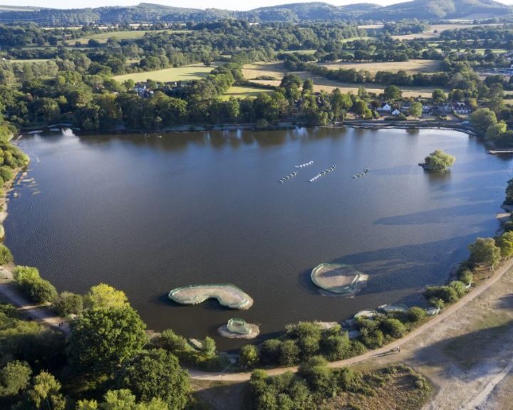 Aerial view of bathroom fitters on a river surrounded by greenery.